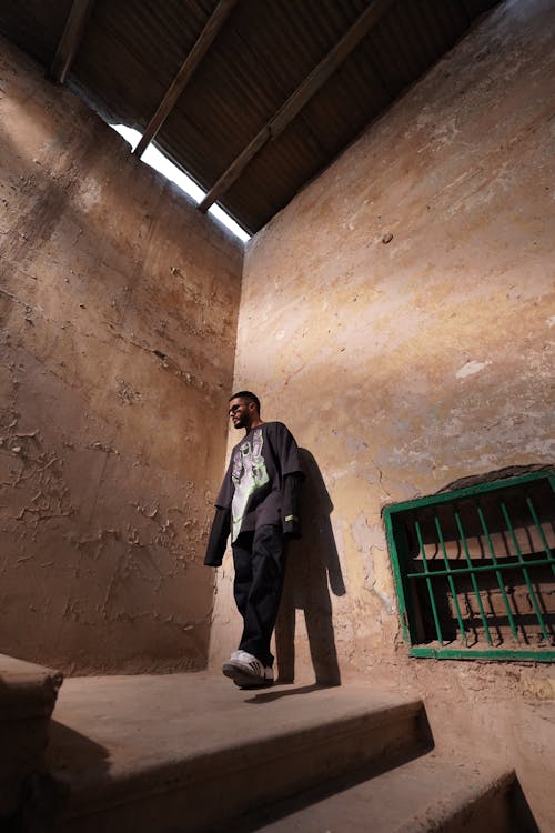 Man on Steps in Abandoned Building