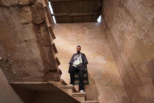 Man on Step in Abandoned Space