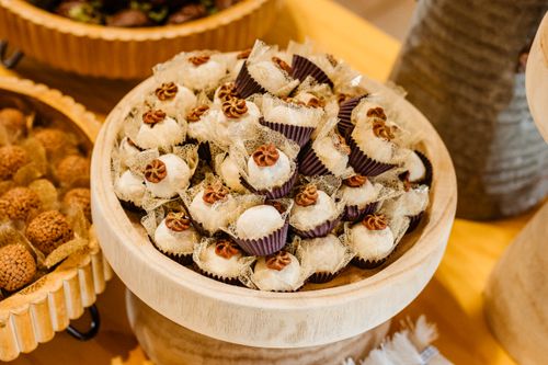 Free Delicious sweet confections beautifully arranged on a wooden stand, perfect for dessert tables. Stock Photo