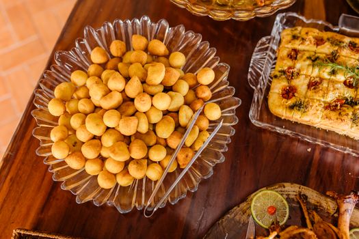 Delicious snacks and focaccia bread served on a wooden table ready for dining.