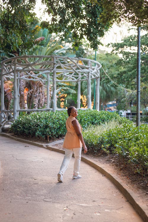 Woman Walking in a Tropical Garden 
