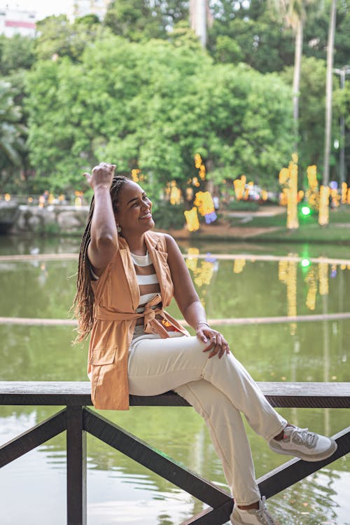 Woman Sitting by the Stream in a Park 