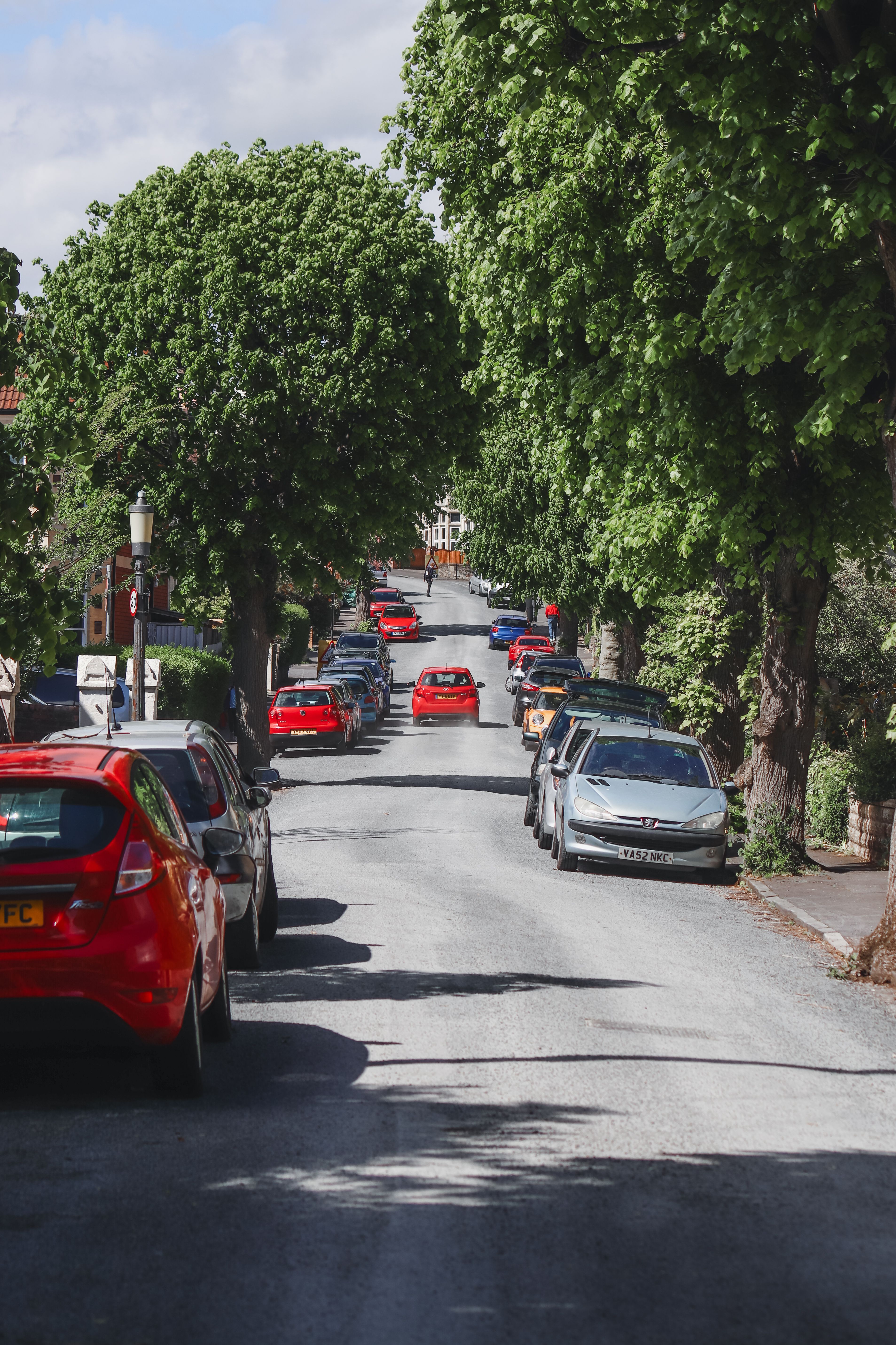 View of Cars Parked on Both Sides of a Street in City · Free Stock Photo