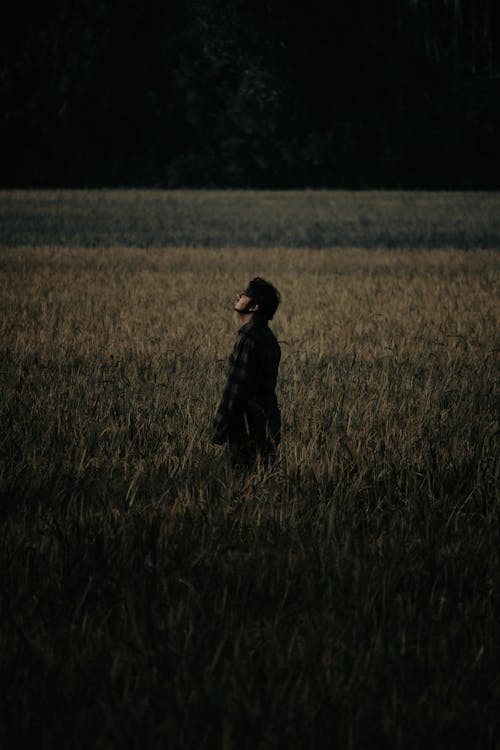 A Man Standing alone on a Field 