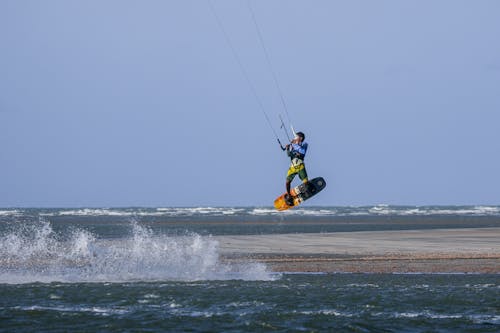 Photo of a Man in the Air while Kitesurfing