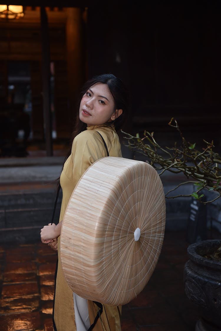 Woman Holding A Bamboo Bowl On Back 