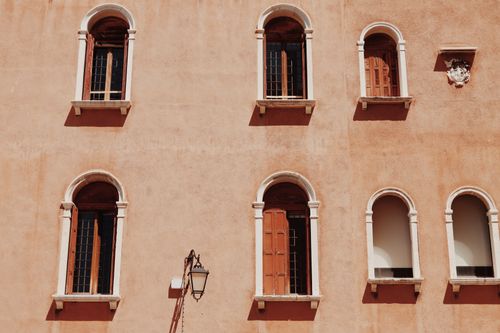 Free Elegant Venetian windows on a historic building facade in Venice, Italy, showcasing classic architecture. Stock Photo