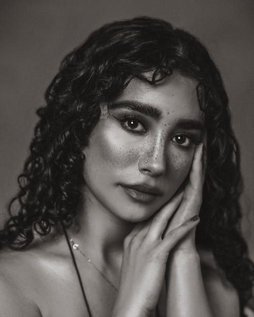 Black and White Portrait of a Young Woman with Curly Hair 