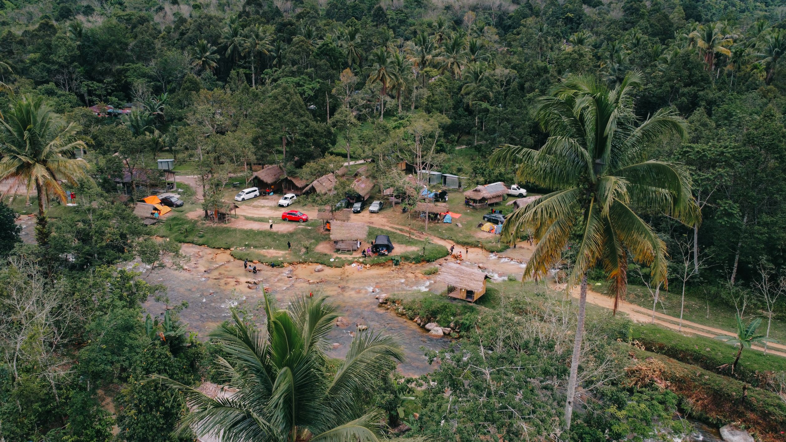 Aerial View of a Resort by a River and Palm Trees · Free Stock Photo