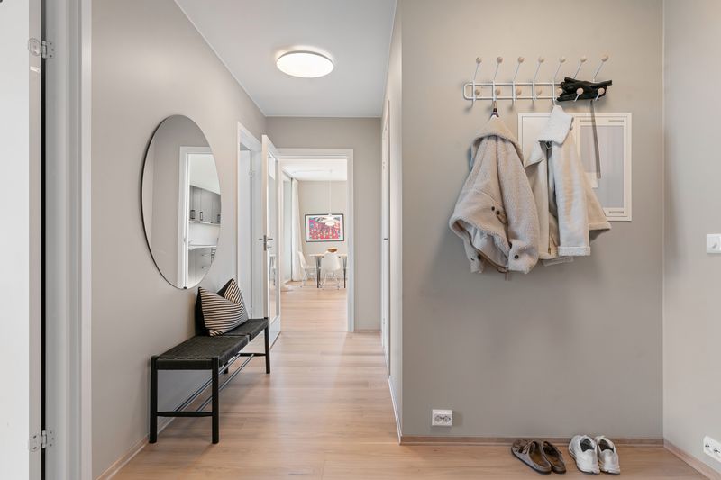 Minimalist apartment entryway with coat storage