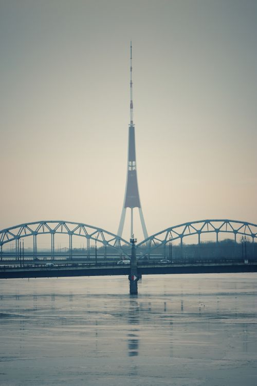 Free A scenic view of the Riga TV Tower with the railway bridge over the Daugava River in Latvia. Stock Photo