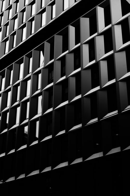 Free Black and white photo of a geometric building facade in Oslo, Norway with glass windows. Stock Photo
