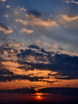 A captivating sunset with dramatic clouds and rich colors filling the sky.