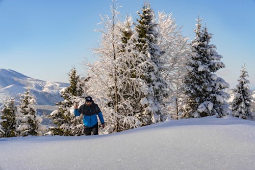 Man Hiking on Hill in Snow