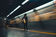 Woman Standing Beside Train Station
