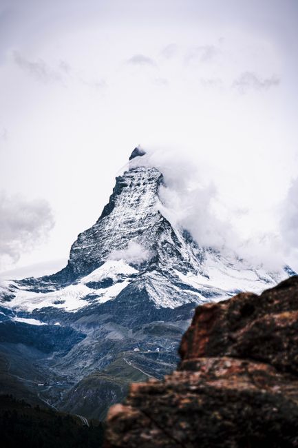 Captivating view of the snowcapped Matterhorn peak surrounded by clouds in Zermatt, Switzerland.