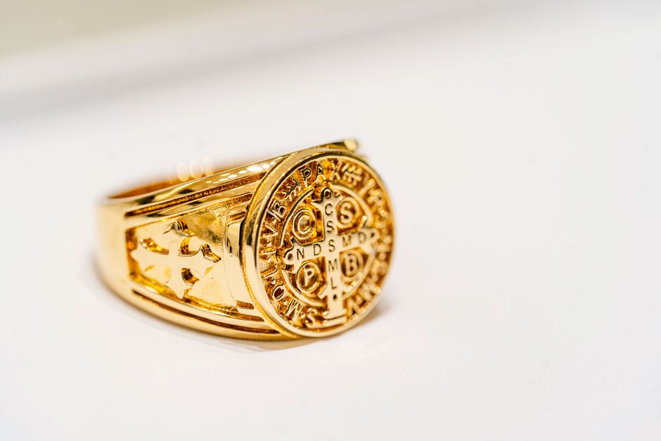 Close-up of a gold signet ring with intricate engraving, captured in Dubai.