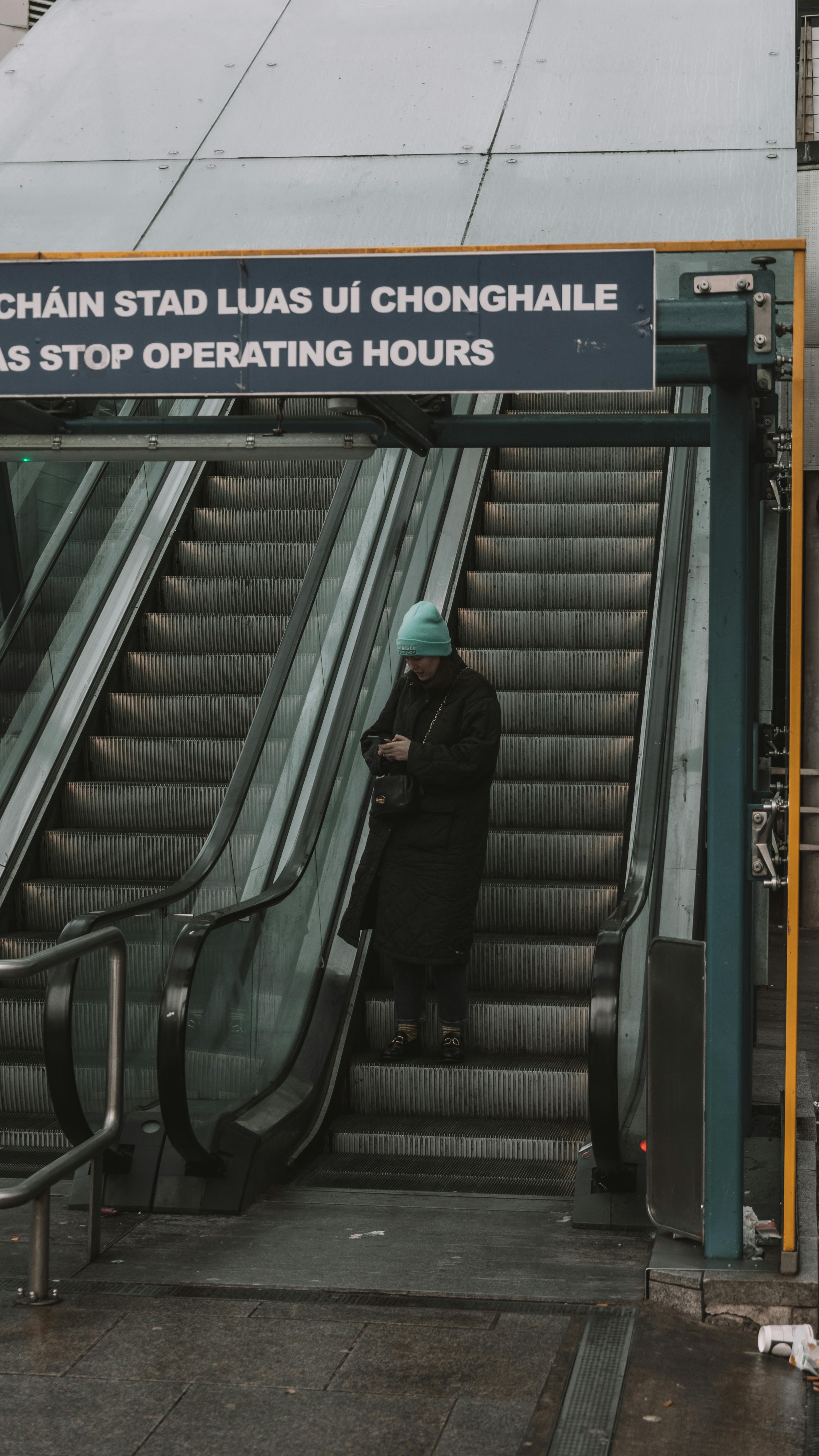 Free Urban scene of a woman on an escalator, capturing the essence of city life. Stock Photo