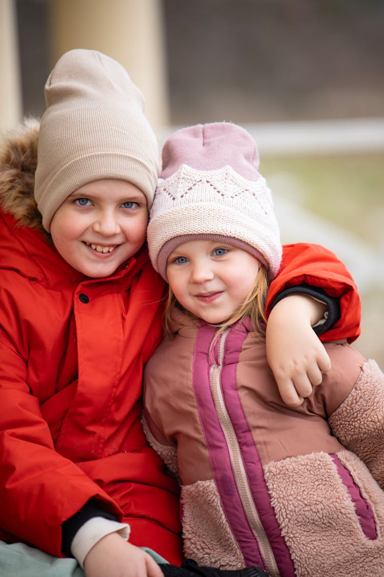 Smiling Brother And Sister In Jackets