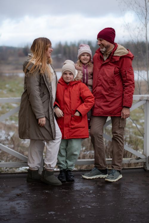 Free A joyful family enjoying the outdoors in winter attire, sharing smiles and warmth. Stock Photo