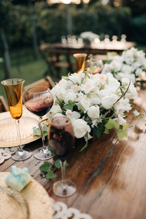 Free Wineglasses and a Bouquet of Flowers on a Banquet Table  Stock Photo