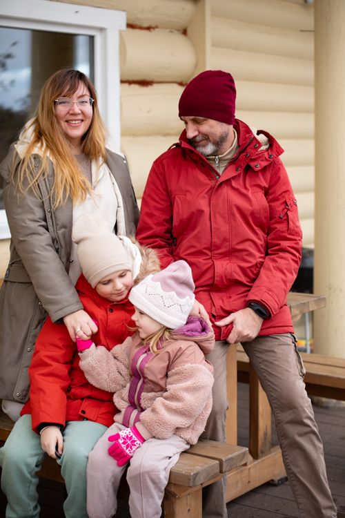 Free A family enjoying a winter day outdoors, dressed in warm clothing. Stock Photo