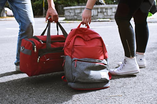 Free Two Person Carrying Duffel and Backpack Stock Photo