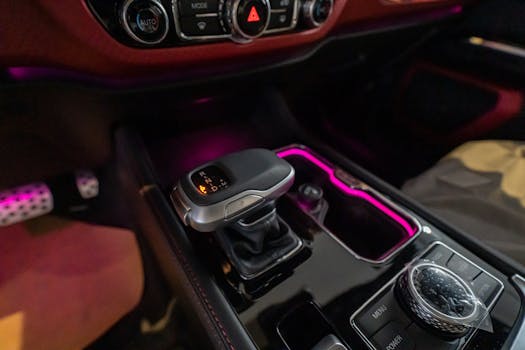 Close-up of a luxury car's gear shift with ambient lighting in Dubai.