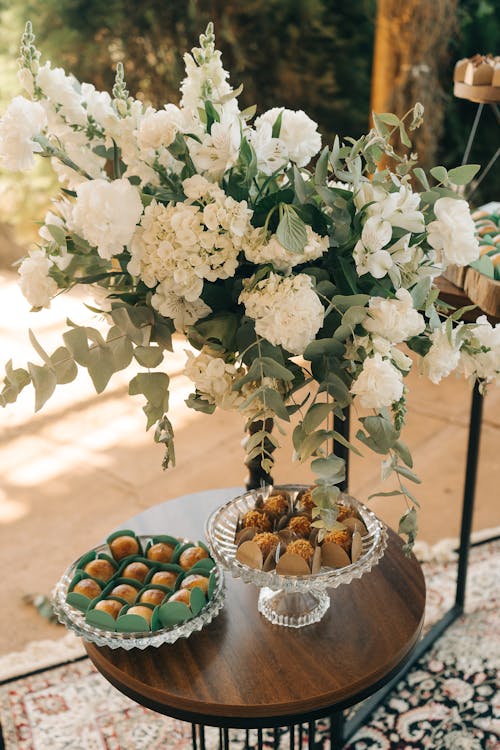 Candies on a Table and a Flower Arrangement 