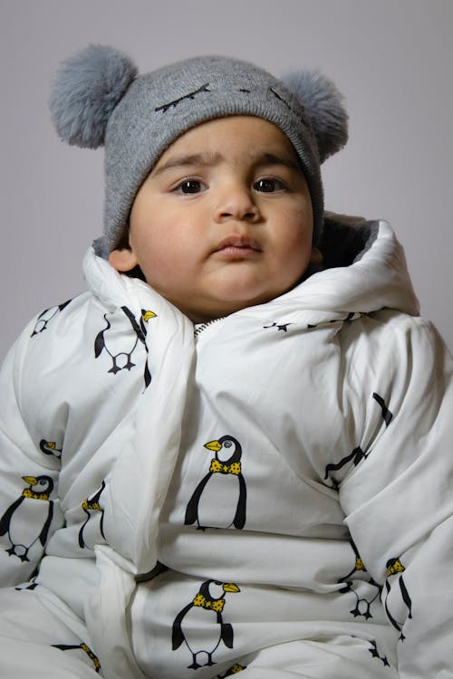 Portrait of Boy in Hat and White Jacket