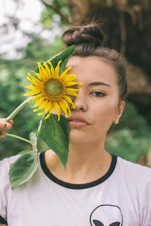 Woman Holding Yellow Sunflower