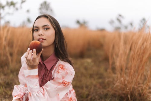 Model Posing with Peach in Rural Scenery