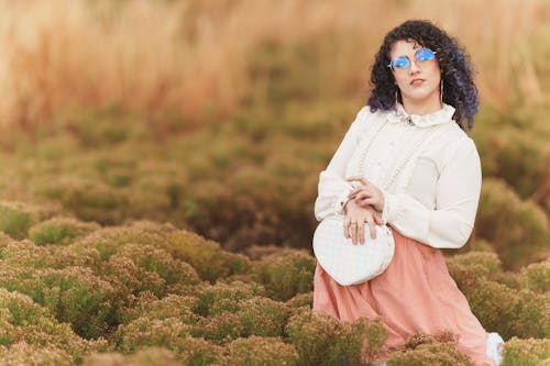 Model Posing with Purse in Rural Scenery