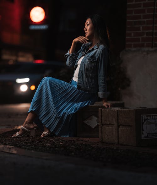 Model Posing in Denim Jacket and Long Skirt in city at Night
