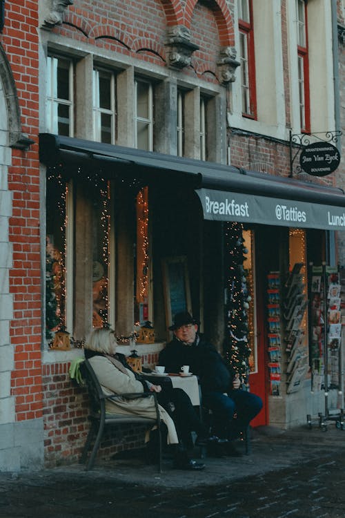 Couple Sitting at Table Outside Store