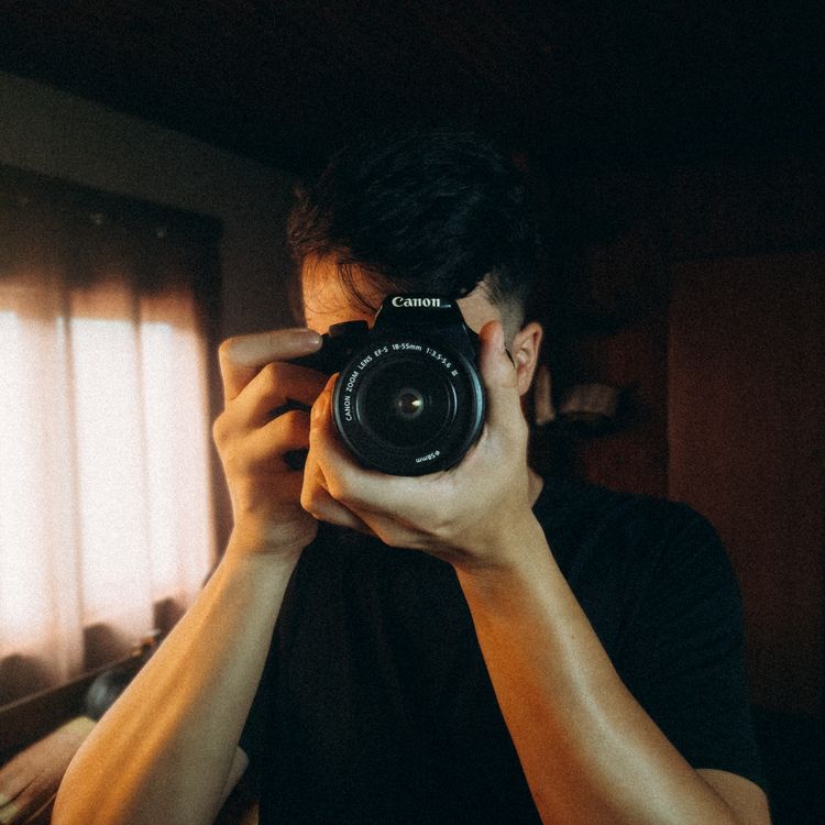 free photo of a man taking pictures with a camera in a room free photo of a man taking pictures with a camera in a room