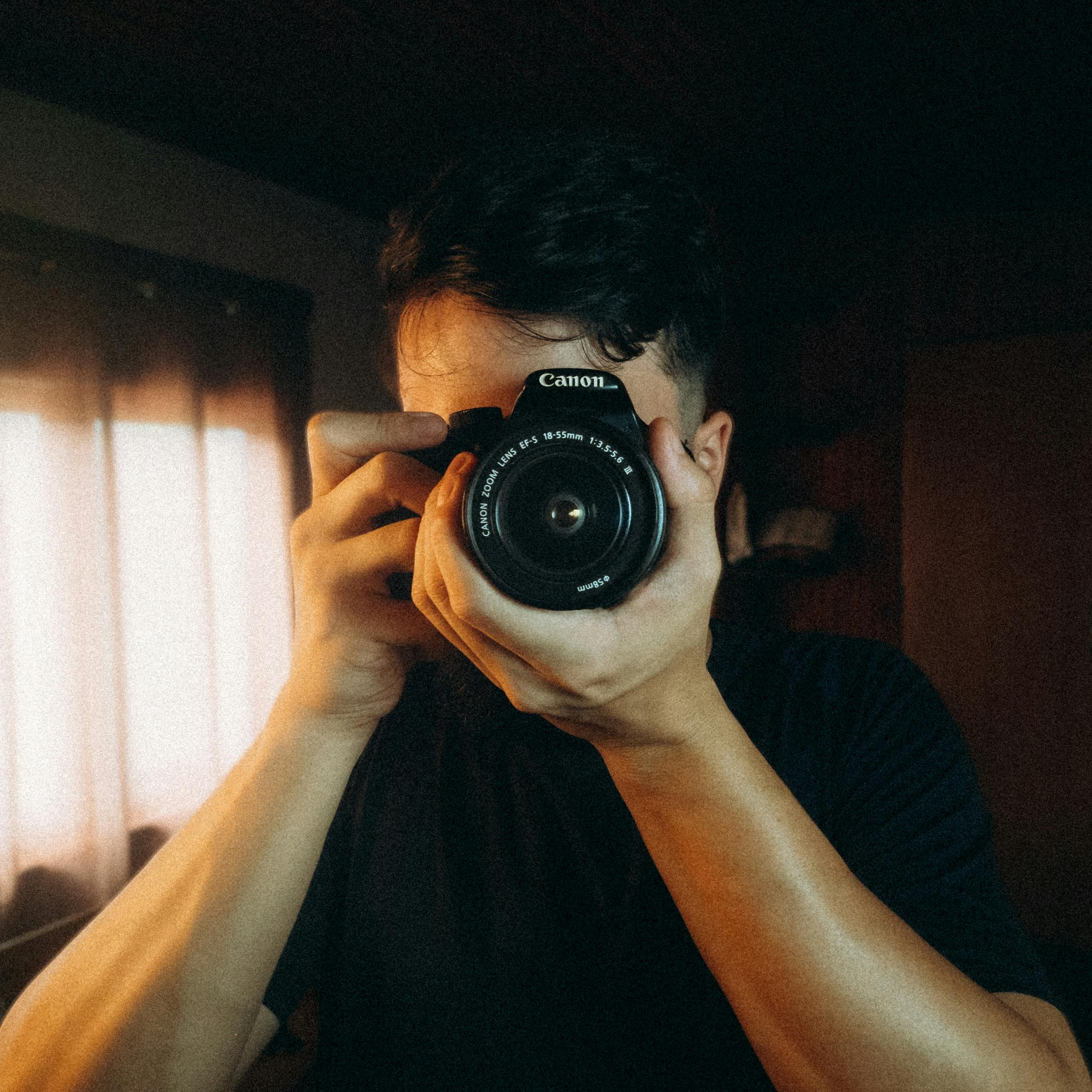 a man taking pictures with a camera in a room