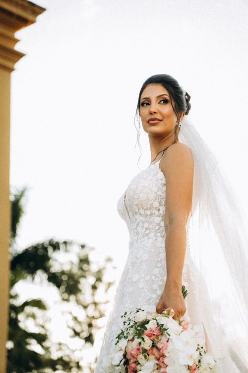 Free Beautiful bride in white lace wedding dress holding bouquet in Tiradentes, Brazil. Stock Photo