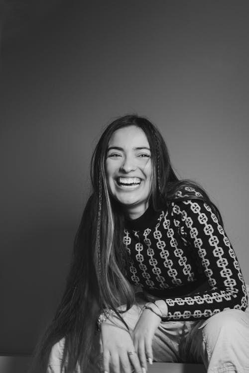 Smiling Woman Sitting in Black and White