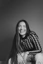 Smiling Woman Sitting in Black and White