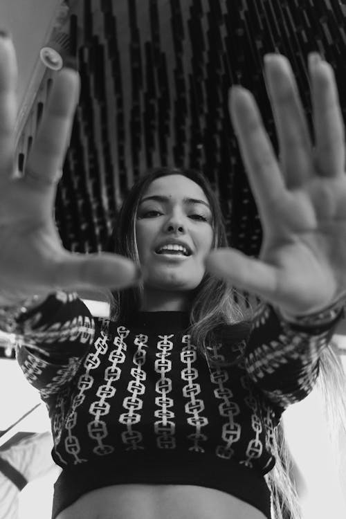 Woman Standing in Top and with Hands Raised