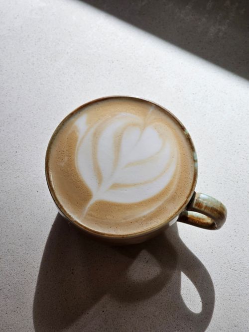 Free A beautifully crafted latte with froth art captured in a cozy Istanbul café. Stock Photo