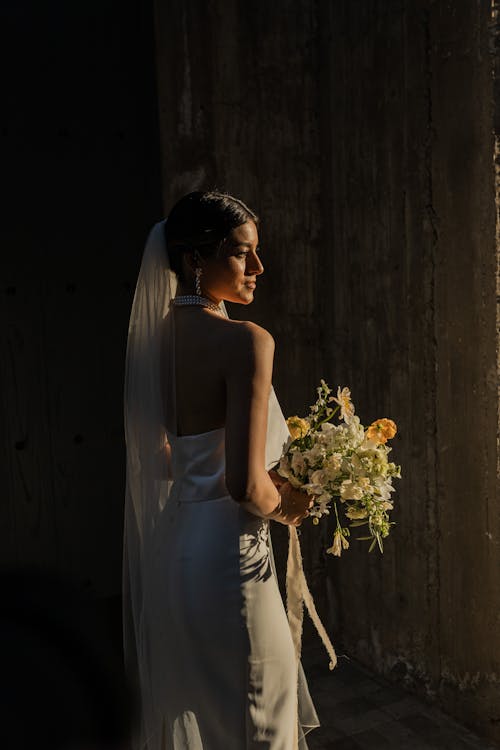 Bride in Wedding Dress and with Flowers Bouquet