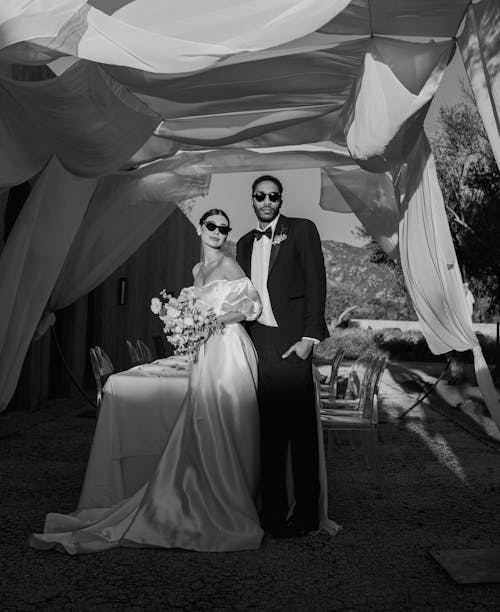 Newlyweds Standing by Table in Black and White