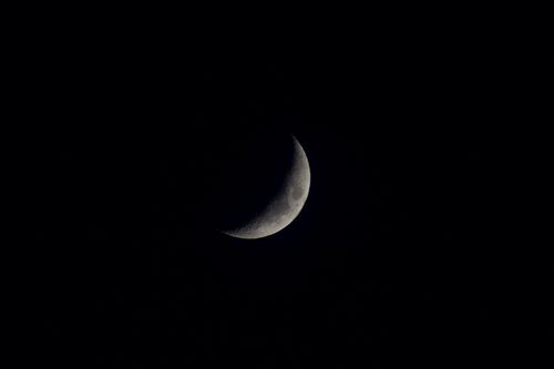 Free A clear view of the crescent moon shining bright against a dark night sky. Stock Photo