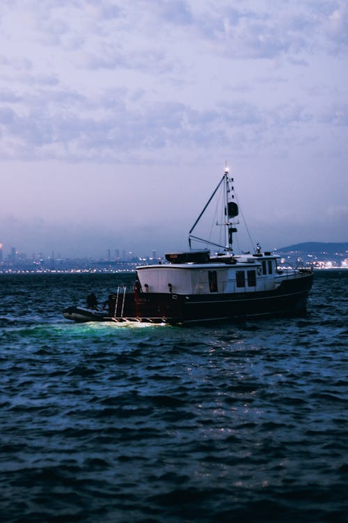 Fishing Boat in Sea at Dawn