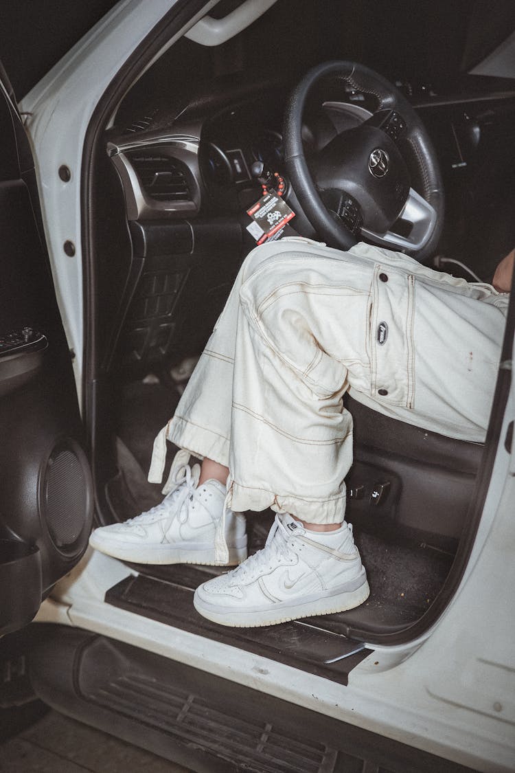 Legs Of A Driver In White Cargo Pants