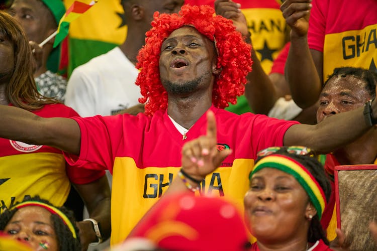 Smiling Soccer Fan In Red Wig