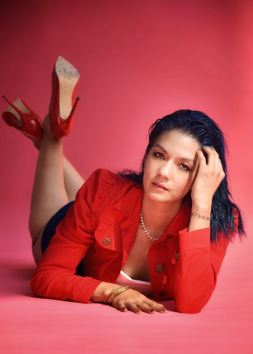 Woman Lying Down in Red Jacket and High Heels