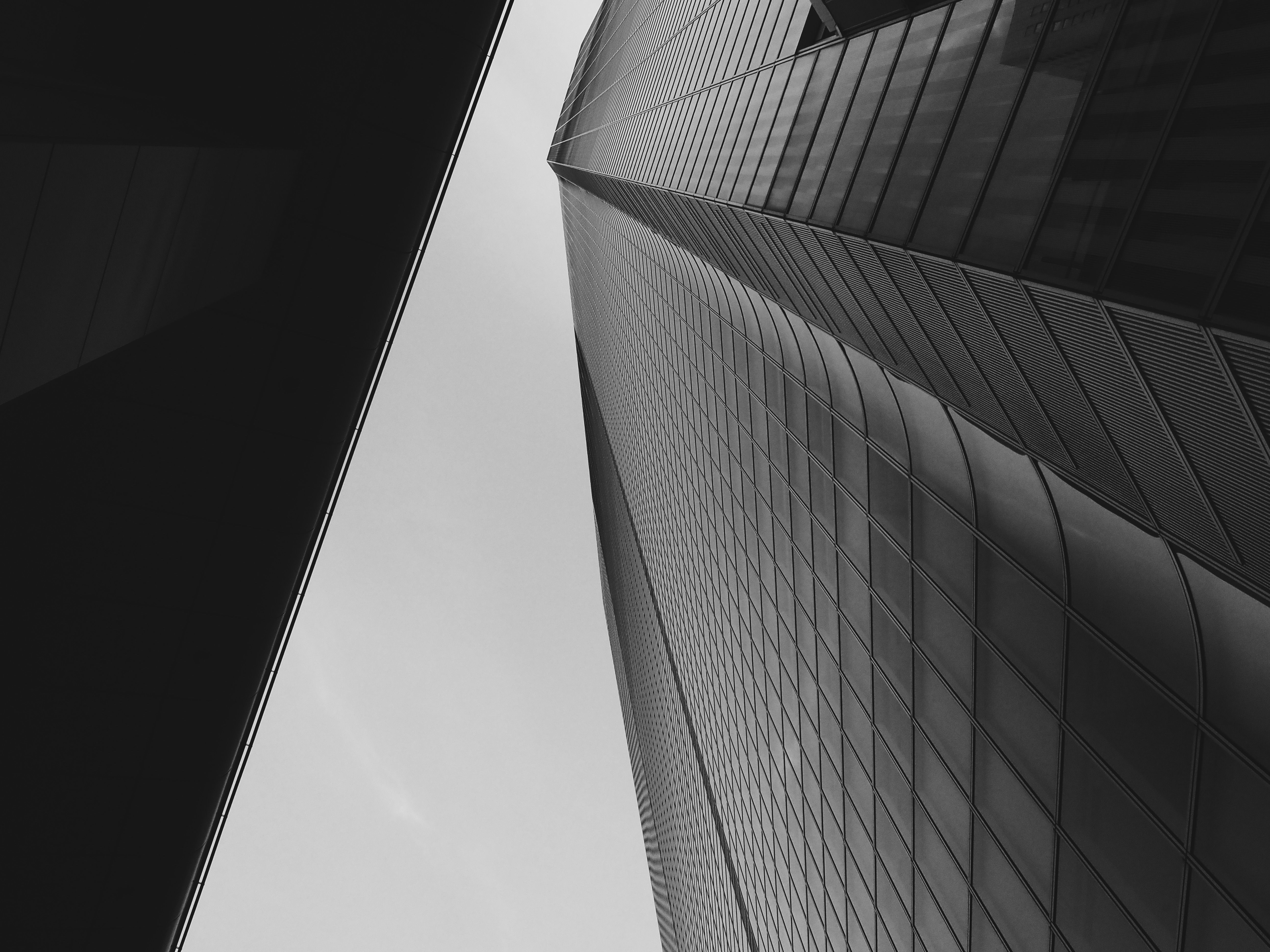 Low angle view of a modern skyscraper in Tokyo, showcasing abstract architectural design.